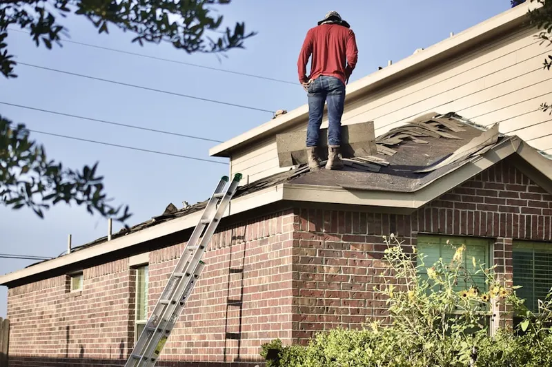 Professional roofer working on a residential roof in Bradford Place